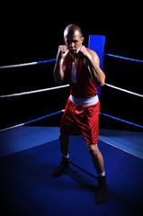 Male boxer in ring doing exercise