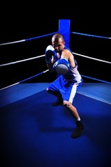 Male boxer in ring doing exercise