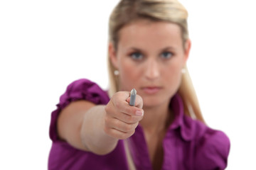 Woman pointing her pen at you