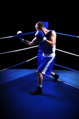 Male boxer in ring doing exercise