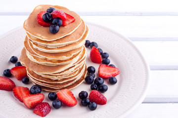 stack of pancakes with strawberry and blueberry