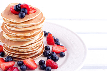 stack of pancakes with strawberry and blueberry
