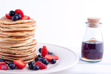 stack of pancakes with strawberry and blueberry