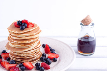 stack of pancakes with strawberry and blueberry