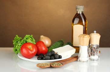 Ingredients for a Greek salad on brown background close-up