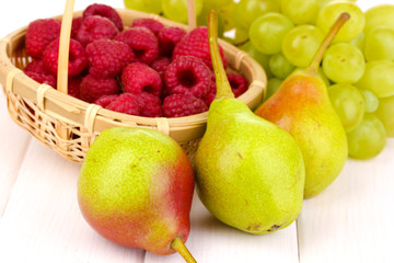 ripe sweet fruits and berries on wooden background