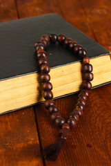 the Wooden rosary beads and holy bible close-up