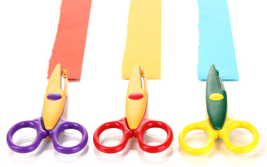 Colorful zigzag scissors with paper strips isolated on white