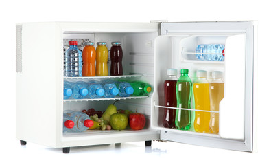 mini fridge full of bottles of juice, soda and fruit isolated