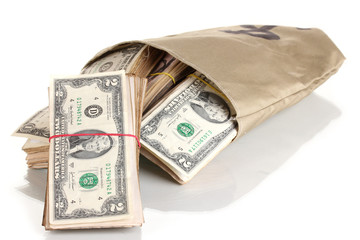 Bag with stacks of dollars isolated on white