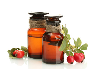 medicine bottles with hip roses, isolated on white