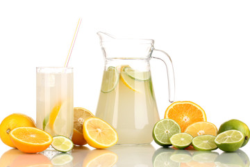 Citrus lemonade in pitcher and glass of citrus around isolated