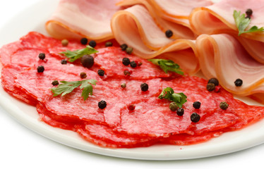 tasty bacon and sausage with spices on plate, isolated on white
