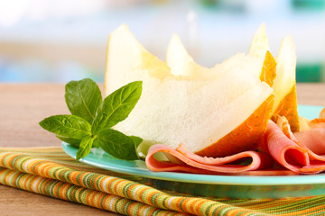 parma ham and melon, on wooden table