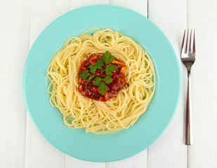 Italian spaghetti in plate on wooden table