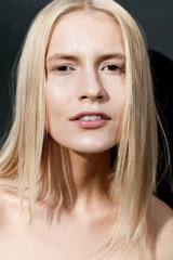 Fototapeta premium fashion model touches face mouth look at camera