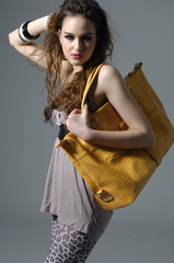 Pretty young girl model with big leather bag