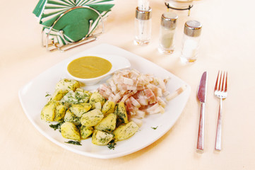 Boiled potatoes with bacon and mustard