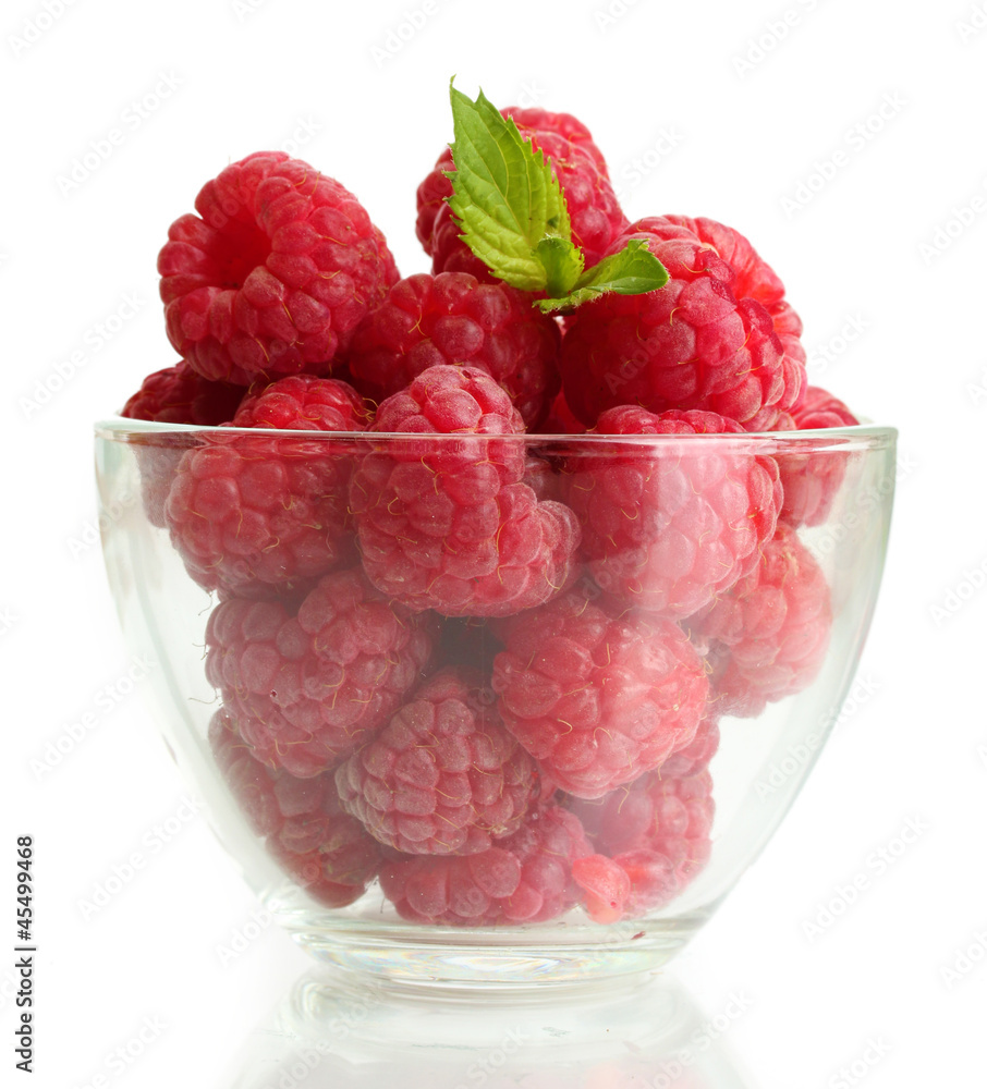 Wall mural ripe raspberries with mint in glass bowl isolated on white