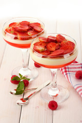 fruit jelly with berries in glasses on wooden table