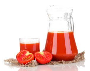 Tomato juice in pitcher and glass on sackcloth isolated on