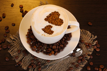 Latte on wooden table on brown background