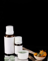Alternative therapies on the tray on black background close-up