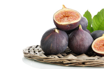 Ripe sweet figs with leaves isolated on white