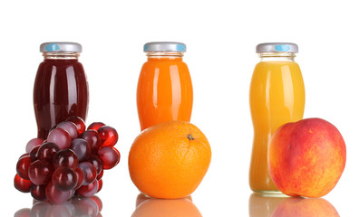 Delicious grapes, orange and apple juice in glass bottle and