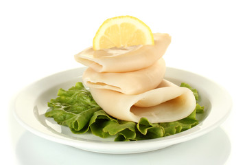 Fototapeta na wymiar boiled squids with lettuce and lemon in the plate isolated