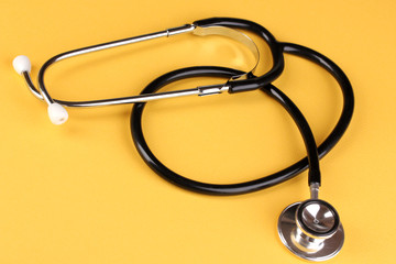 Stethoscope on orange background