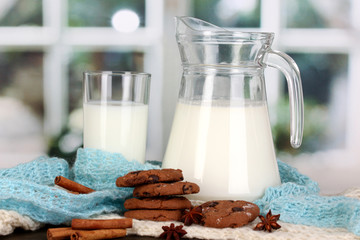Pitcher and glass of milk with cookies