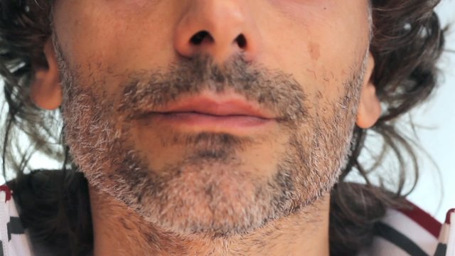 unshaven man smoking