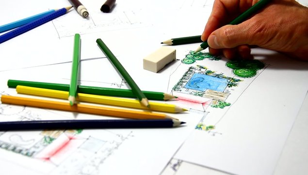 Man sketching on a landscape drwaing.