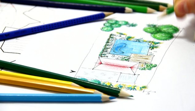 Man sketching on landscape drawing.