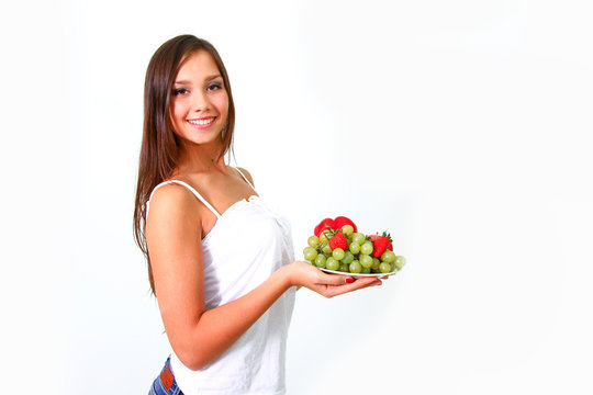 Young woman with fruits and vegetables on a dish
