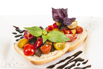 juicy tomatoes on fresh bread, pesto as topping