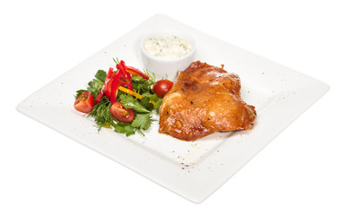 roasted chicken with vegetables on a white plate