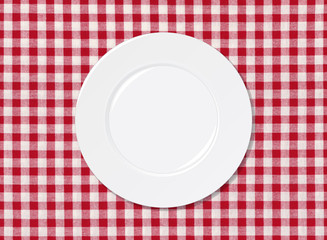 White plate on red and white striped seamless tablecloth