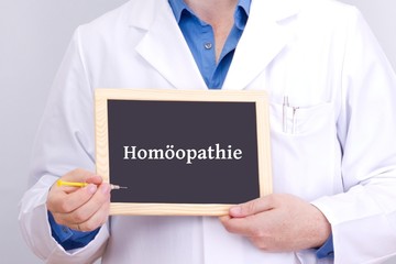 Doctor shows information on blackboard: homeopathy