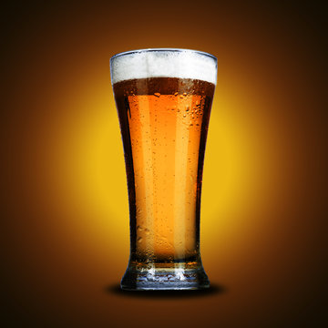 glass of beer on yellow background