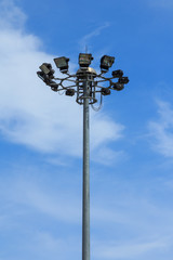 Stadium light pole on blue sky background