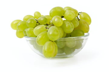 ripe grapes in a glass bowl on a white background
