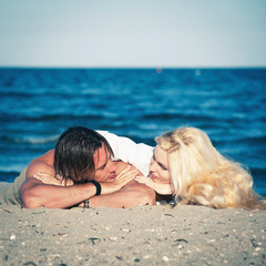 Young couple in love relaxing at the beach.