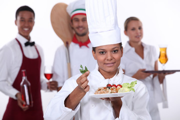 female chef presenting a plate