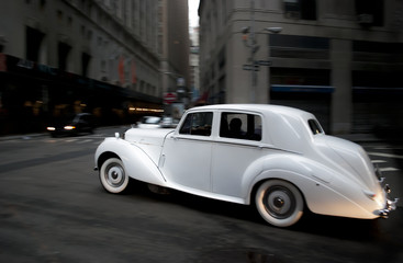 Fototapeta na wymiar Classic Wedding Car in movement