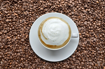 Cappuccino on coffee beans