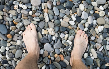 Male legs on pebble