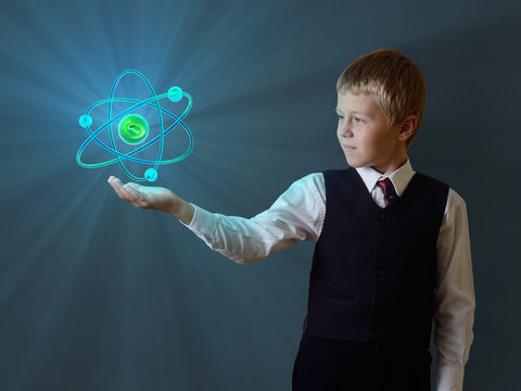 schoolboy holding glowing atom