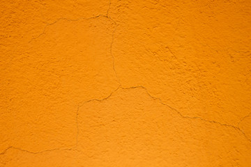 Orange cracked plaster wall